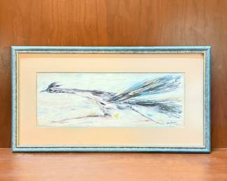 The artwork features an abstract depiction of a roadrunner in flight. The bird is primarily black and white, with a splash of colors including blue and yellow. It is framed in a turquoise-colored frame that has a distressed finish. The signature 'DeGrazia' is visible in the bottom left corner of the artwork, along with the text 'Arizona' beneath it. Lithograph on paper.
