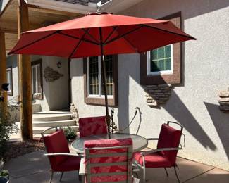 Patio table with matching chairs and umbrella
