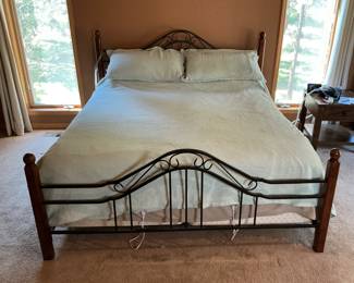 King bed in metal and wood frame.