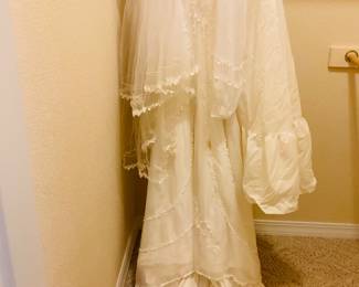 Wedding dress, owner states dress is size 9, zippered back, petticoat slip. No tags.