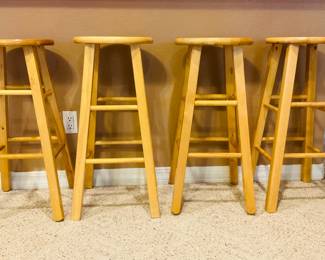 our (4) light wood bar stools