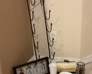 Bathroom necessities include: towel rack, large rectangular candle, soap dish and more.