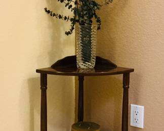 Corner shelf with home accents featuring a corner table