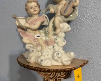 Wall shelf with ceramic cherubs