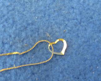 Lot 22. 14-kt gold necklace with a small heart pendant weighing 1.04 grains and one earring marked Mexico 525