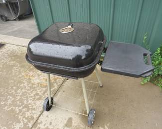 Lot 310. Portable charcoal grill with side table