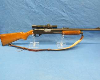 Lot 378. Remington 870 Wingmaster 12-gauge pump shotgun. Ser #1064843V. 20" slug barrel with a 2 3/4" chamber, Weaver K1.5-1 scope, and a leather sling.
