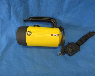 Lot 287. Ikelite underwater Super 8 flashlight with a Cetacea retractable lanyard. Untested.