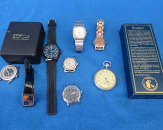 Lot 74. Nine wristwatches and one pocket watch: Daniel Steiger Statue of Liberty, Stauer quartz Centurion with a leather wristband, and more