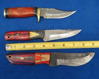 Lot 229. Three fixed-blade knives with leather sheaths, two are Damascus knives