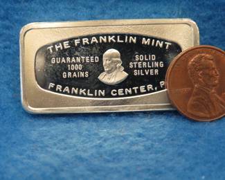 Lot 46. Franklin Mint Bank-marked sterling silver ingot. 64.8 grams.