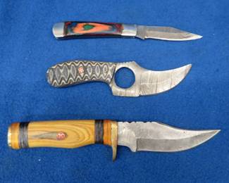 Lot 226. Two fixed-blade knives and one folder with leather sheaths made of Damascus