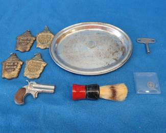 Lot 75. Renaissance Fair medallions, streetcar token, 2-headed novelty quarter, shaving brush, cap gun, silver plate tray, Girl Scout silverware, clock key