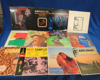 Lot 411. 12 LPs including Eddie Money, Johnny Cash, Tom Petty, Lynyard Skynyrd, and more