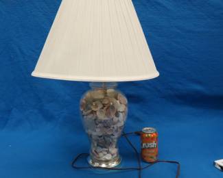 Lot 61. Table lamp filled with seashells