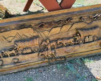 Wood carved wall art of covered wagons