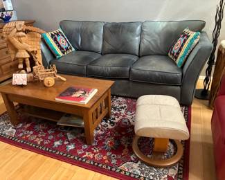 Green leather couch, rug, ottoman