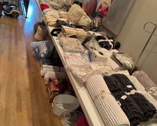 Large amount of bedding, bath decor and rugs, blankets