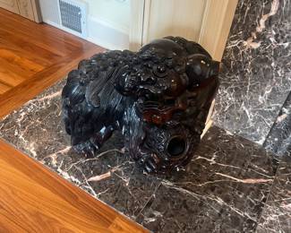 One of a pair of carved Rosewood Foo dogs. Approx. 18"w x 18"h x 1"d.