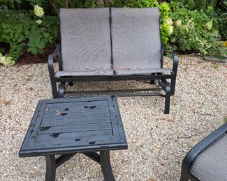 Rocker loveseat by Tropitone. 51"w x 28"d x 37.5"h. One of a pair of 24"sq. by 24"h side tables