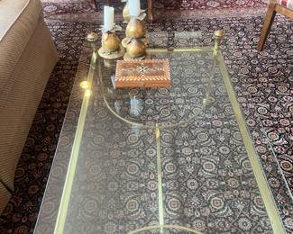 A brass and glass coffee table. 41.75 inches wide by 25.5 inches deep by 18 inches high.