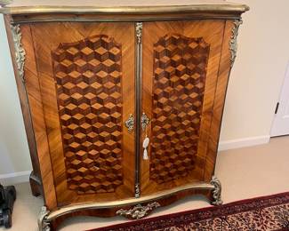 $700. Beautiful brass trimmed patterned chest. 41.5 inches wide by 17.5 inches deep by 46.5 inches high.