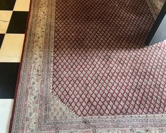 An antique rug 100% wool. 4’ 10” x 6’ 10”.