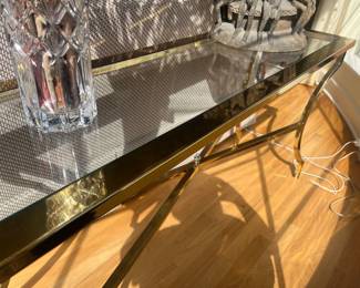 A brass and glass console table. 54 inches wide by 16 inches deep by 27.25 inches high.