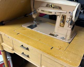 Vintage Singer sewing machine in cabinet