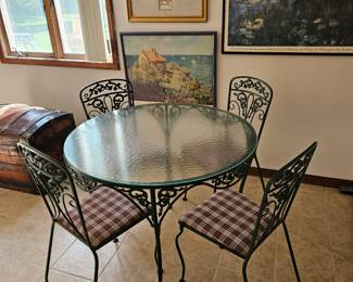 404. Iron table with glass top, 4 chairs, art