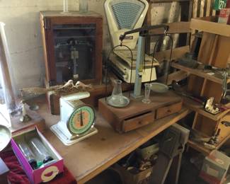 11., pharmacy scales, wooden storage containers with drawers.
