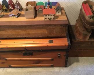 288. nice trunk, then a wooden storage box, with town sets on top.