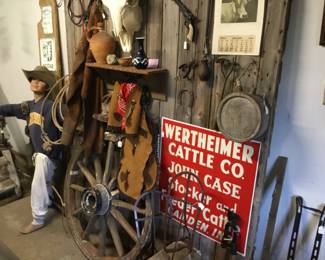 23. Wagon wheel, cowboy hat , chaps, jugs. Canteen 
