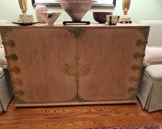 Large vintage two door cabinet with pickled finished and carved brass accents.