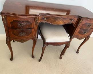 Elegant vanity with matching bench.