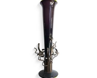 “Purple Tendril Vessel” (2000), Elin Christopherson

Blown glass & metal work; signed by artist
6”w (at top and base) X 25” h

Possible comp based on eBay sale of similar work by artist = $3,150

In addition to her skill in glass arts, Elin has experience in metal lathe and milling machine operations, steel fabrication, including MIG and TIG welding, and wood carving and construction. She has also used factory production methods to create multiple parts for sculpture and public art. To date, she has created large scale glass artwork in the public realm for two libraries, a park, a civic center, two medical centers, and an outdoor mall.

