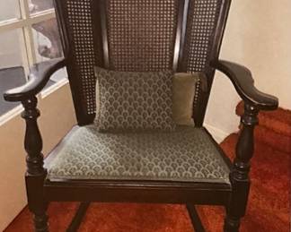 A 1920s Wing Back Cane Side Rocking Chair