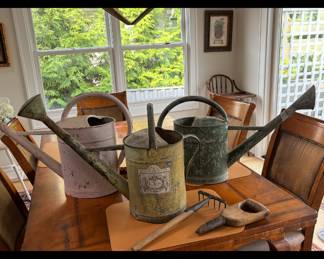Vintage watering cans and garden tools
