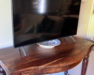 curved front console table and Samsung TV