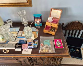 Watches, misc. pieces, a bag of scrap jewelry with a great craft idea framed next to it.