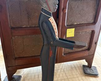 Vintage bellhop statute and antique pie safe