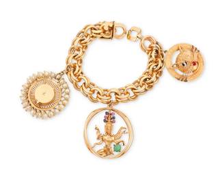 13
A 14K Gold and Gem-Set Charm Bracelet
Featuring three large charms including a cultured pearl and gold locket, a six-armed deity and a "You are the Cat's Meow" cat

Length: 9 in., Charms: 1 1/2 in. and 1 3/4 in.
131.8 grams gross
Estimate: $4,500 - $5,500