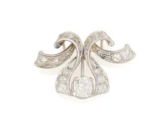 112
A Platinum and Diamond Pendant
Former brooch turned pendant centering a cushion-cut diamond weighing approximately 1.35 carats, accented by old mine-cut diamonds weighing approximately 1.54 carats

Measures: 1 3/8 x 1 in.
7.6 grams gross
Estimate: $3,500 - $5,500
