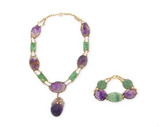 65
A 14K Gold, Amethyst and Jade Necklace and Bracelet Set
Featuring round, oval and square carved jade links, accented by carved oval amethyst links, finished with seed pearl connectors, necklace suspending a carved amethyst fruit
2 pieces

Necklace: 15 1/2 in., Bracelet: 7 1/2 in.
65.6 grams gross
Estimate: $1,500 - $2,000