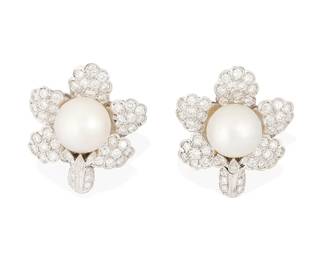 76
A Pair of 18K White Gold, Cultured Pearl, and Diamond Earclips
Centering cultured pearls measuring approximately 13.30 mm, set in a floral design set with round diamonds weighing approximately 3.70 carats
2 pieces

Measures: 1 1/4 x 1 1/8 in.
24.0 grams gross
Estimate: $4,000 - $6,000