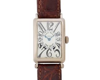 294
Franck Mueller: A 18K White Gold 'Long Island' Watch
Dial: 17.10 mm, rectangular with Arabic hour markers
Model: Long Island, 956 032
Case: 23.12 mm
Case number: 234
Closure: brown leather strap with 18k white gold buckle claps
Signed:dial, case and clasp

Inner circumference: 6 1/2-8 1/2 in.
50.8 grams gross
Estimate: $3,000 - $5,000
