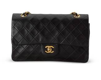 28
CHANEL: A Black Leather Medium 25 Timeless Classic Sac Rabat Double Flap Bag
Circa 1997-1999; France
Marked to interior: Chanel / ® / Made in France; Carte D'Authenticité and interior tag: 5195704
A double flap diamond matelasse lambskin bag with 24k gold-plated turn-lock clasp and hardware, exterior pocket, a pull-through leather chain handle, and with burgundy red leather interiors with a second snap flap, and multiple interior pockets, with (original) box and dust bag

6 1/4 x 10 x 2 3/4 in.; strap drop: 9 1/2 in. to 16 in.
Estimate: $1,200 - $1,800