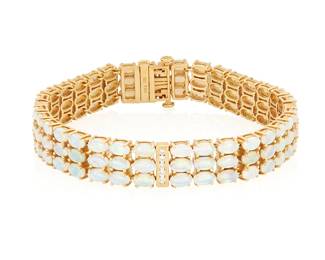 162
An 18K Gold and Opal Bracelet
Featuring three rows of oval opal cabochons accented by gold bars set with round diamonds

Length: 7 1/8 in, Width: 3/8 in.
32.4 grams gross
Estimate: $3,000 - $5,000