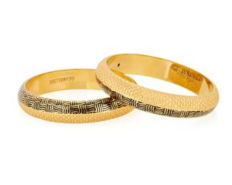 226
A Pair of 22K Gold and Enamel Bangles
Of a textured gold design featuring crosshatch motifs of black enamel
2 pieces

Measures: 7 1/4 in.
60.7 grams gross
Estimate: $4,000 - $6,000