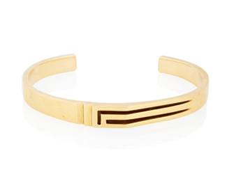 129
An 18K Gold Cuff Bracelet
Of a high polish design featuring a geometric carved element

Cuff: 5 1/2 in., Gap: 1 1/4 in.
41.2 grams gross
Estimate: $1,200 - $1,500